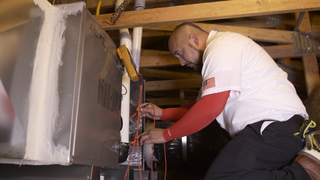 hvac technician performing inspection to reduce risk of carbon monoxide poisoning