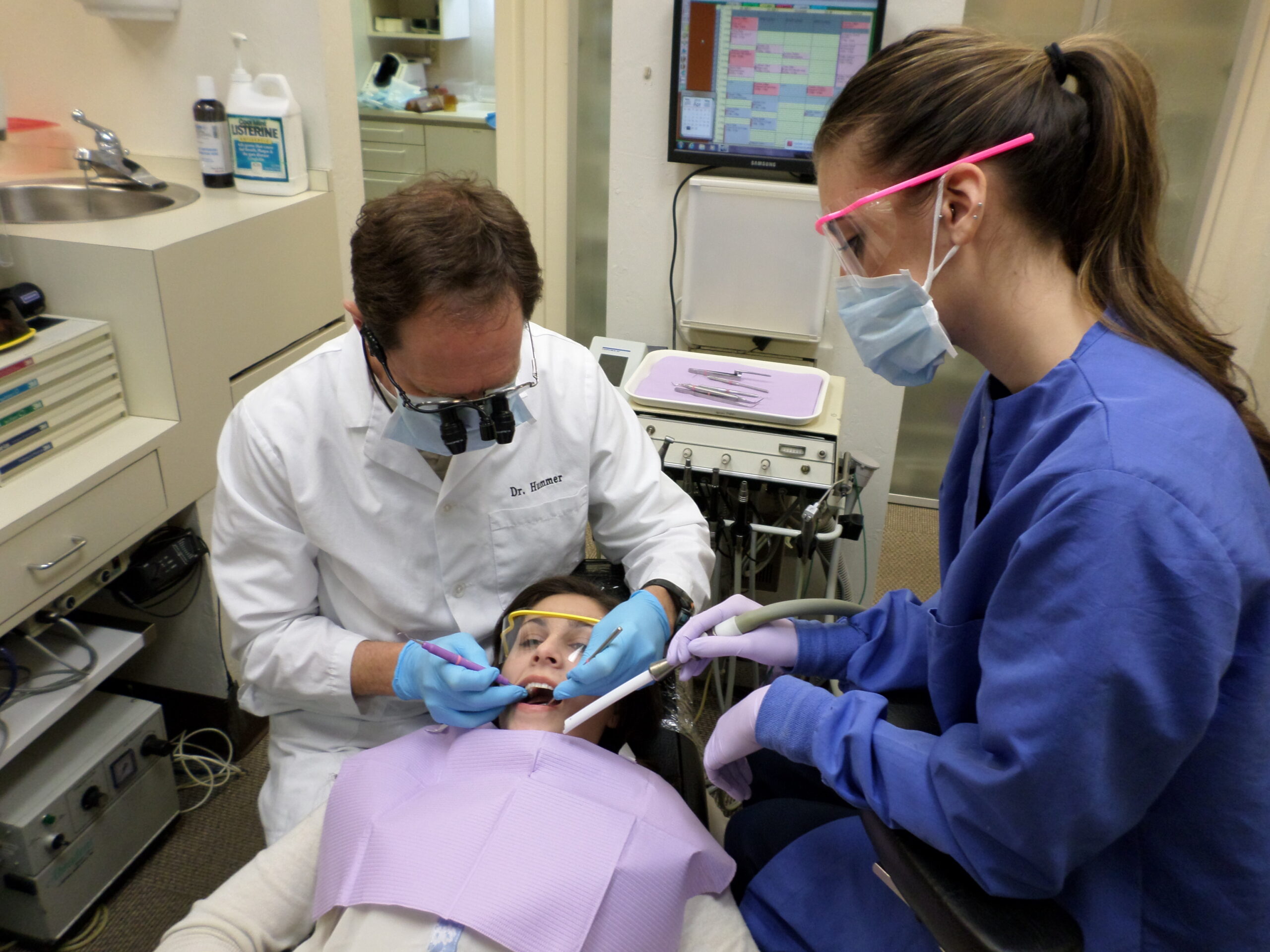 dentist and hygienist caring for a patient