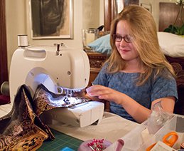 Chris enlisted her 10-year-old neighbor, Alice Doyle Taylor, to help her make new bathroom curtains. Photo: Chris Bjorklund, 2016